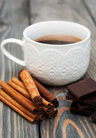 cup of coffee with cinnamon sticks and chocolateの写真素材