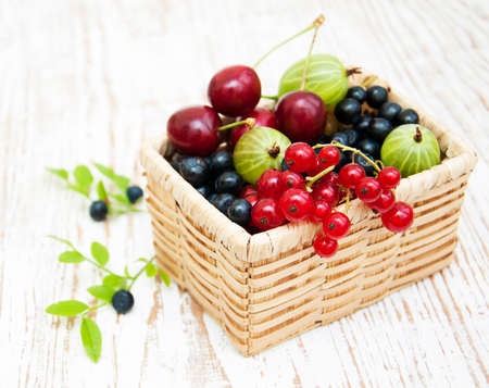 Assorted fresh berries on a wooden  backgroundの写真素材