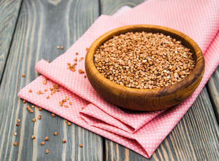 Bowl with Buckwheat on a wooden backgroundの写真素材