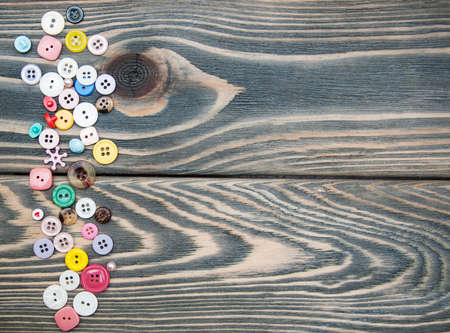 Mixed Sewing Buttons on a wooden backgroundの写真素材