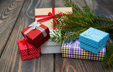 christmas trees with heap of gift boxes on a wooden backgroundの写真素材