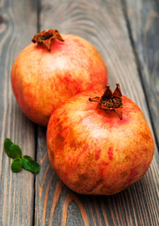 juicy pomegranates on a old wood background