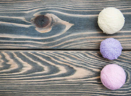 color woolen clews for knitting on a wooden backgroundの写真素材