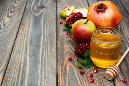 honey  apple and pomegranate on a wooden tableの写真素材
