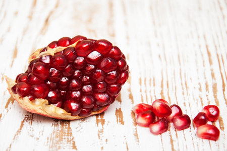 juicy pomegranate on a old wood backgroundの写真素材