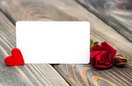 Fresh Red rose and card on a wooden  backgroundの写真素材
