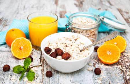 Healthy breakfast - orange juice  and muesli with nutsの写真素材