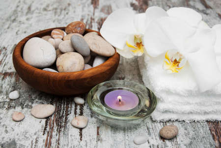 spa still life - a flower and towels on a wooden backgroundの写真素材
