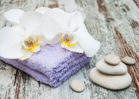 spa still life - a flower and towels on a wooden backgroundの写真素材