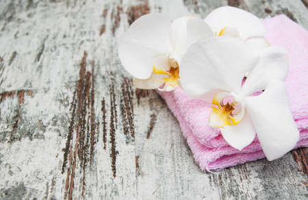 spa still life - a flower and towels on a wooden backgroundの写真素材