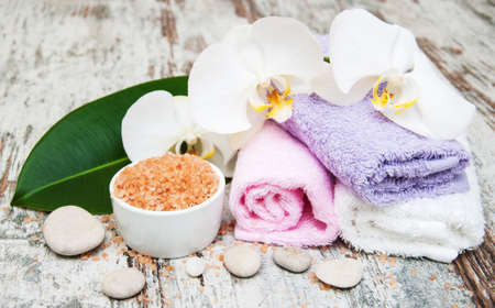 spa still life - a flowers  and towels  on a wooden backgroundの写真素材