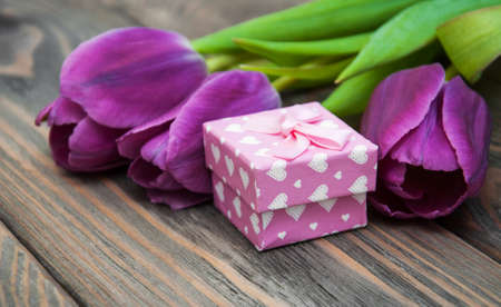 Tulips with gift box on a wooden backgroundの写真素材