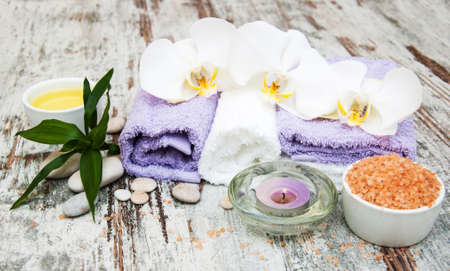 spa still life - a flowers  and towels  Ion a wooden backgroundの写真素材