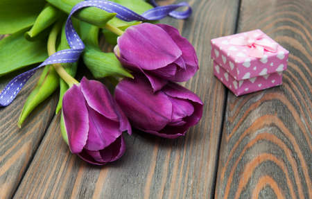 Tulips with gift box on a wooden backgroundの写真素材