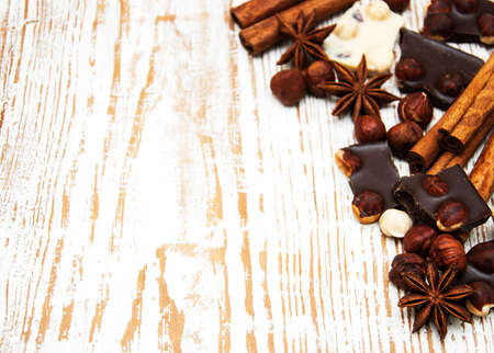 Dark and white chocolate with nuts and spices  on a wooden backgroundの写真素材
