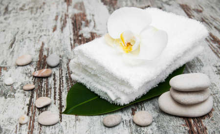 spa still life - a flowers  and towels  on a wooden backgroundの写真素材