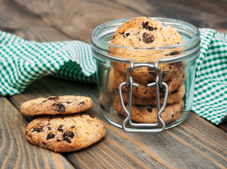 Jar with Chocolate cookies on a wooden background