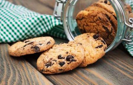 Jar with Chocolate cookies on a wooden background