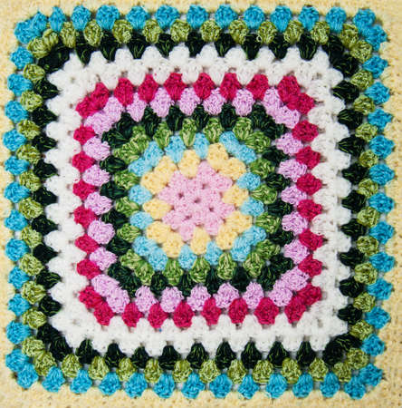multicolored plaid square of crocheted - close upの写真素材