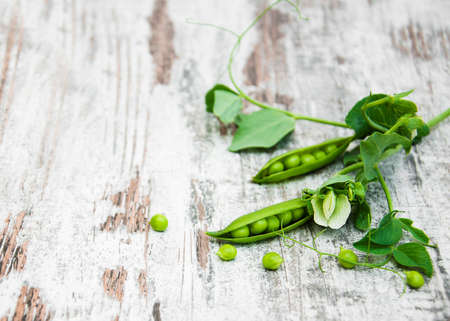 green peas with leaf and flower on a old wooden backgroundの写真素材