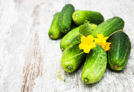 Fresh cucumbers on a old wooden backgroundの写真素材