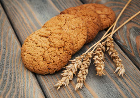 Oatmeal cookies on a old wooden backgroundの写真素材