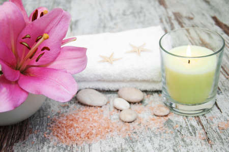 Spa products with pink lily on a old wooden backgroundの写真素材