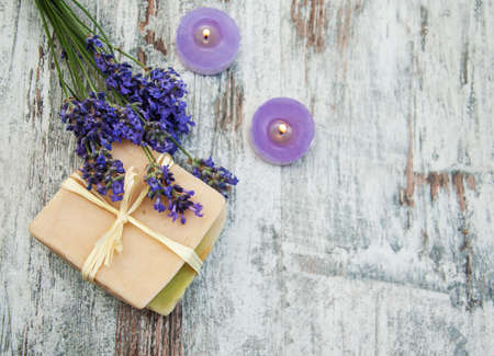 Lavender, handmade soap and  candles  on a wooden backgroundの写真素材