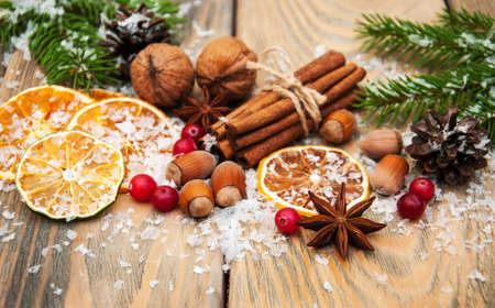 different kinds of spices  and dried oranges with christmas treeの写真素材