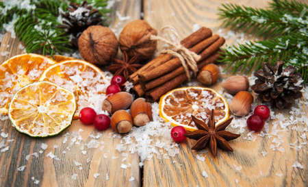 different kinds of spices  and dried oranges with christmas treeの写真素材