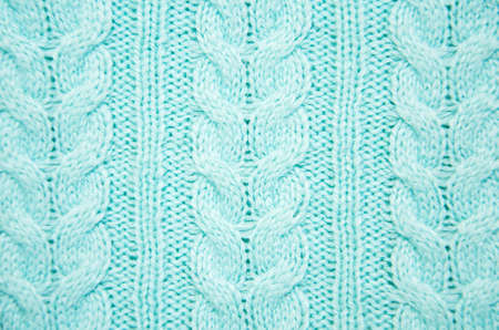 knit texture of blue wool knitted fabric with cable pattern as background