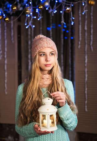 Pretty girl with flashlight in Cristmas decorationsの写真素材