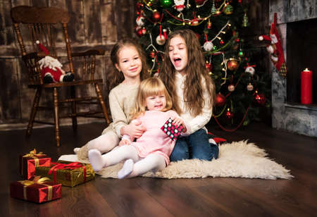 christmas happy funny children - three  girls huggingの写真素材