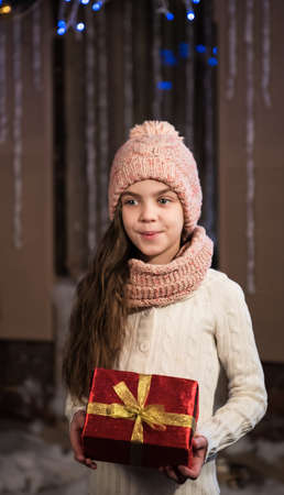 happy little smiling girl with  christmas gift box