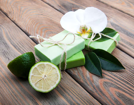 Nature Handmade soap with orchid and lime on a old wooden backgroundの写真素材
