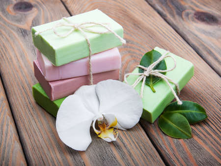 Natural handmade soap with orchid on a old wooden backgroundの写真素材