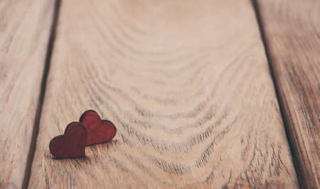 Two red hearts on a old wooden background - vintage toningの写真素材
