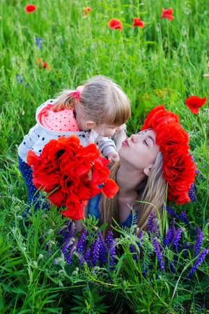 two beautiful  sisters  in the  poppy fieldの写真素材