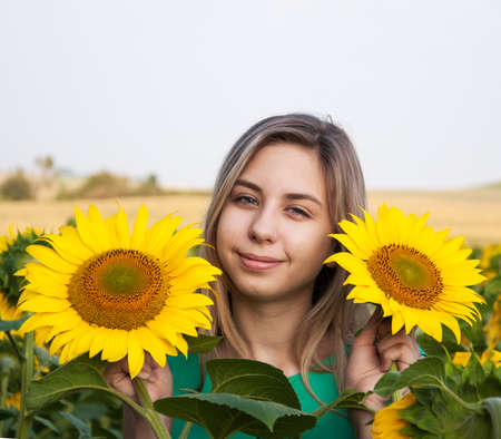 Beautiful  girl on the field of sunflowersの写真素材