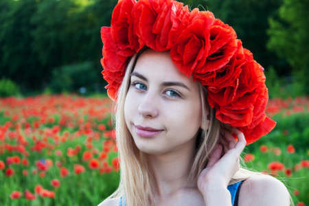 Beautiful young girl in the poppy field