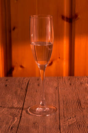 A glass with a clear drink on a wooden backgroundの写真素材