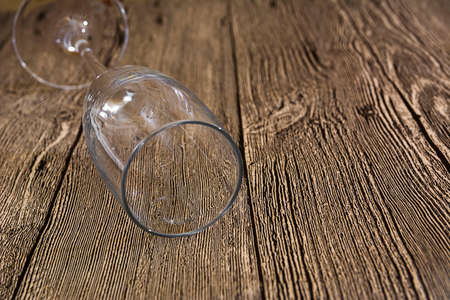 Empty wine glass lay on wooden backgroundの写真素材