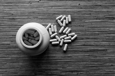 The medicines scattered from a bottle as capsulesの写真素材