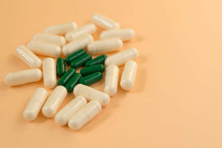 Colorful white and green medical drugs pills capsules closeupの写真素材