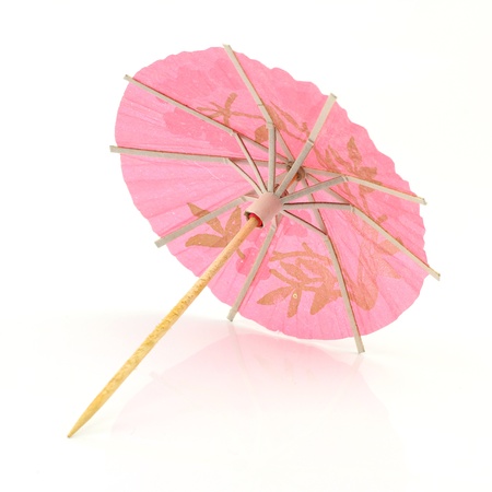 pink cocktail umbrella isolated on white backgroundの写真素材