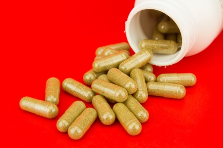 Herbal Pills On Red Backgroundの写真素材