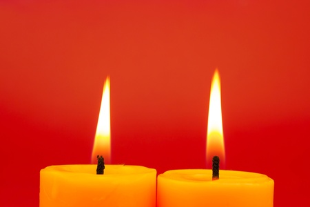 Candles Burning On Red Backgroundの写真素材