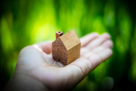 wooden model house in handの写真素材