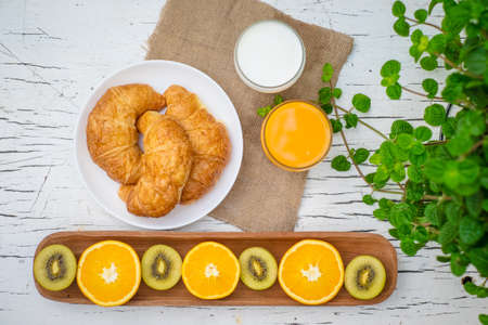 fresh bread fresh fruit orange juice and milkの写真素材