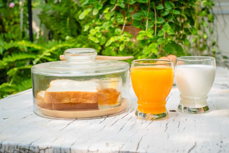 orange juice milk and fresh breadの写真素材